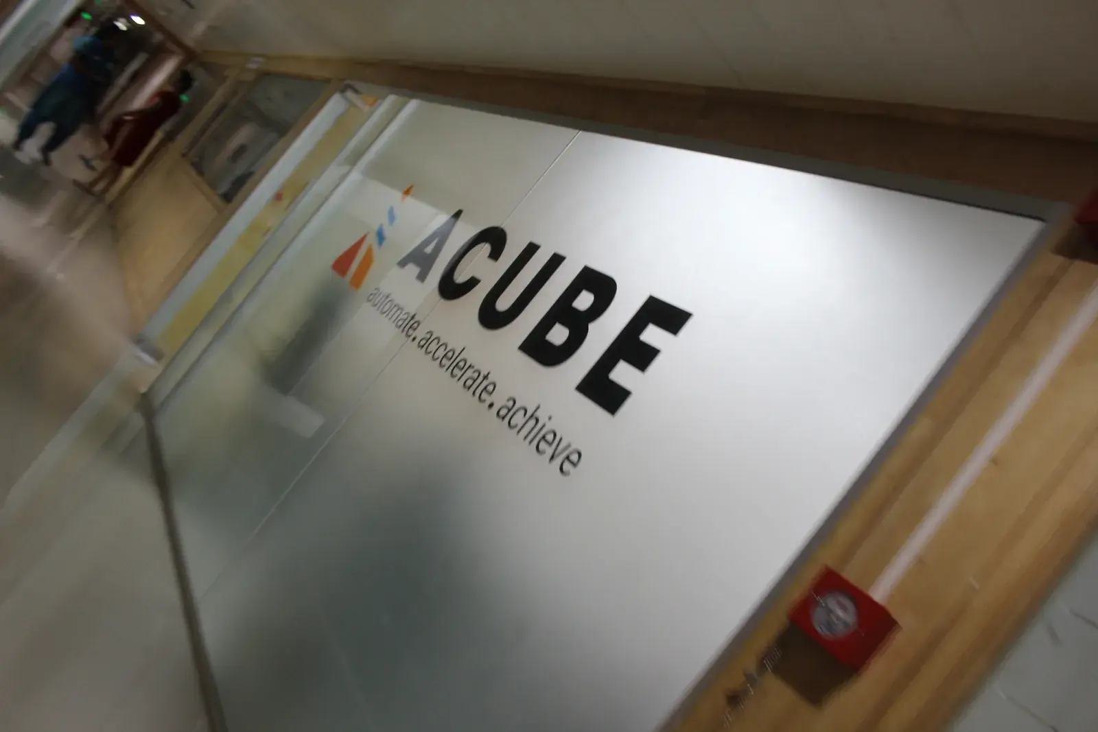 The Acube Innovations office sign in Kochi reading automate, accelerate, achieve