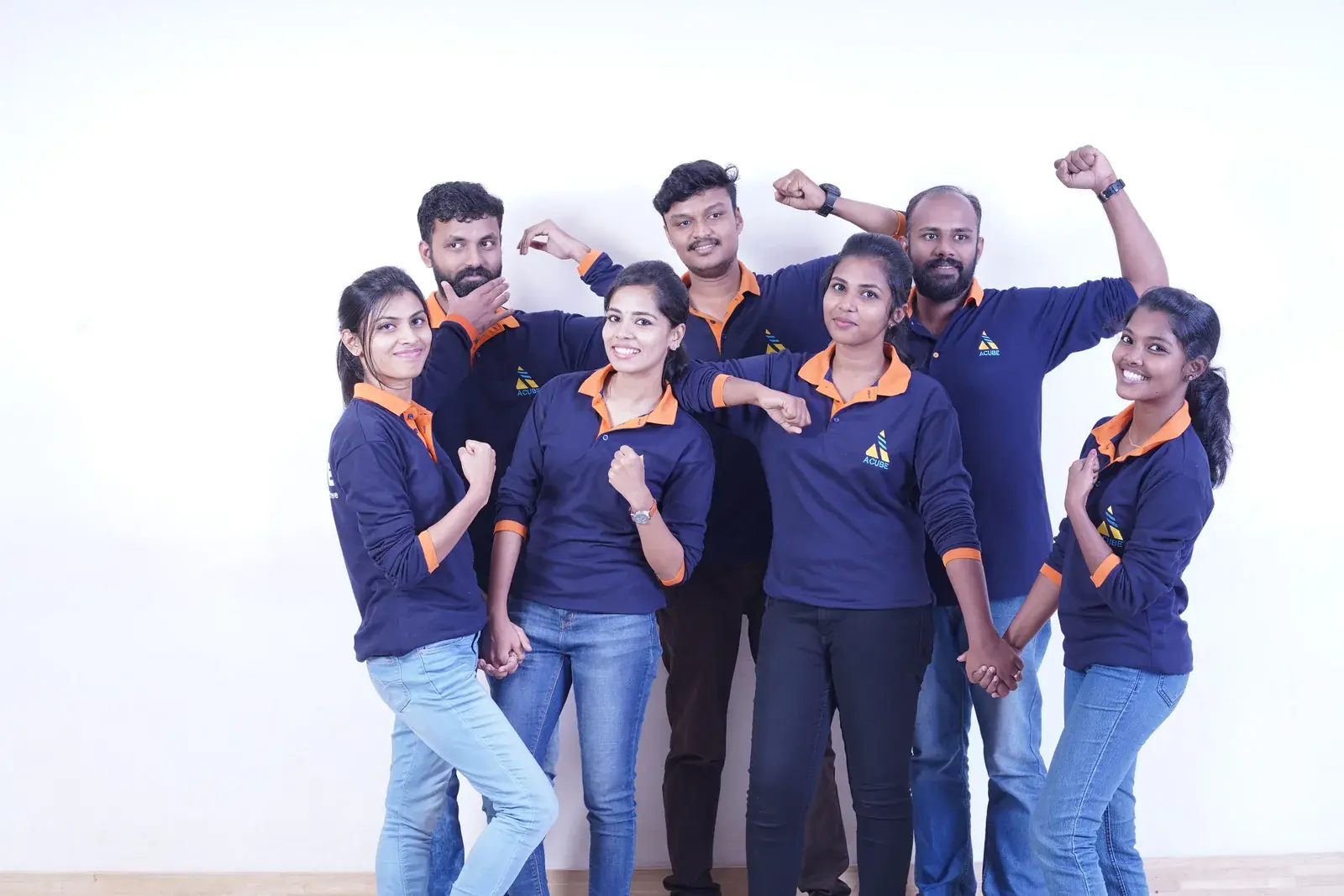 The Acube Innovations team celebrating together in branded shirts