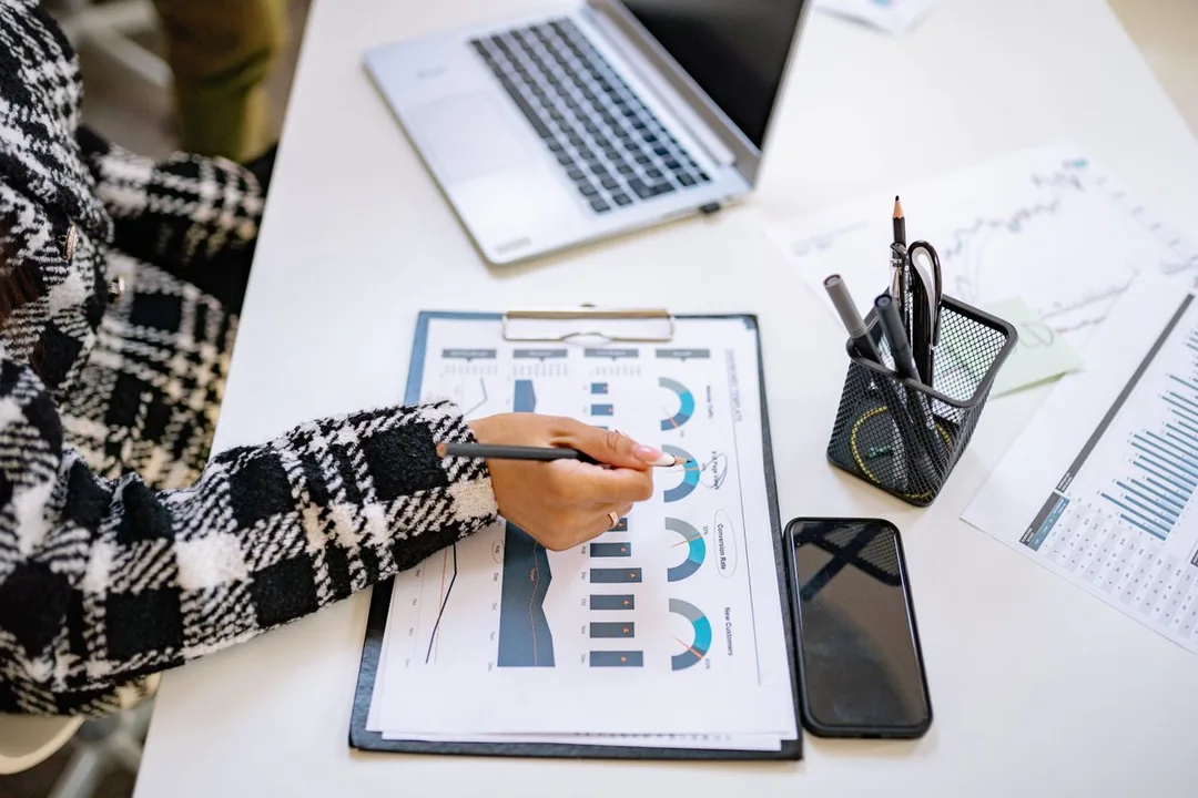 Printed charts and reports being reviewed at a desk