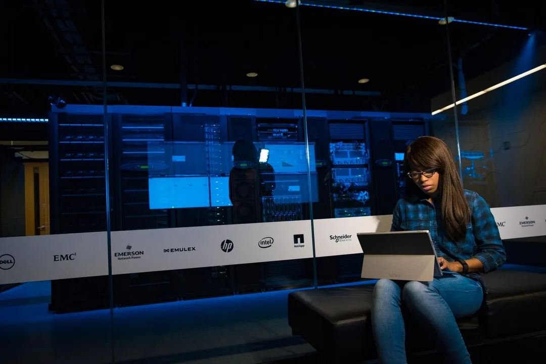 Engineer working on a laptop inside a data centre
