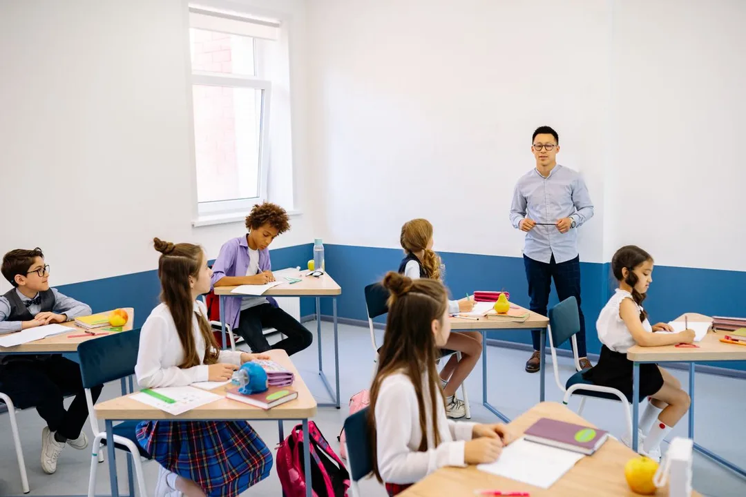 Teacher with students at their desks in a classroom