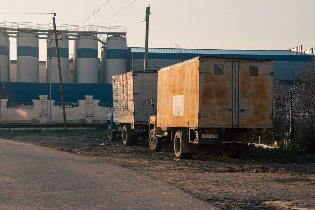 Goods trailer parked outside an industrial yard