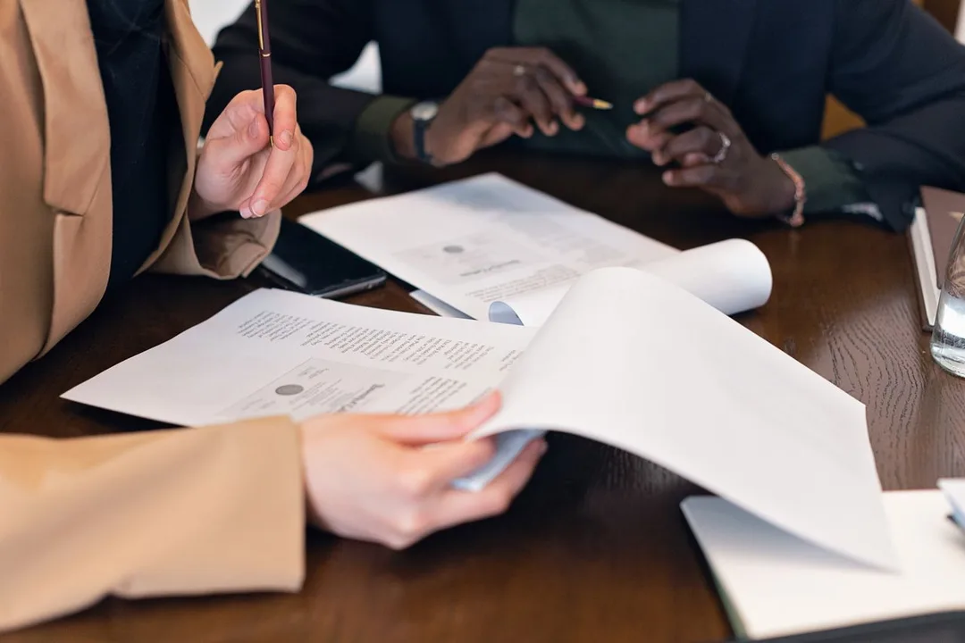 Customer and officer going through loan documents at a desk
