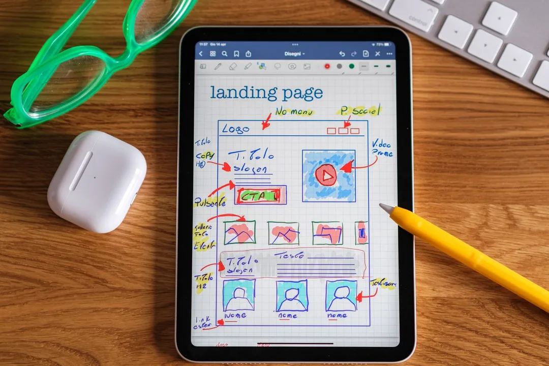 Tablet showing hand-drawn wireframes for a landing page