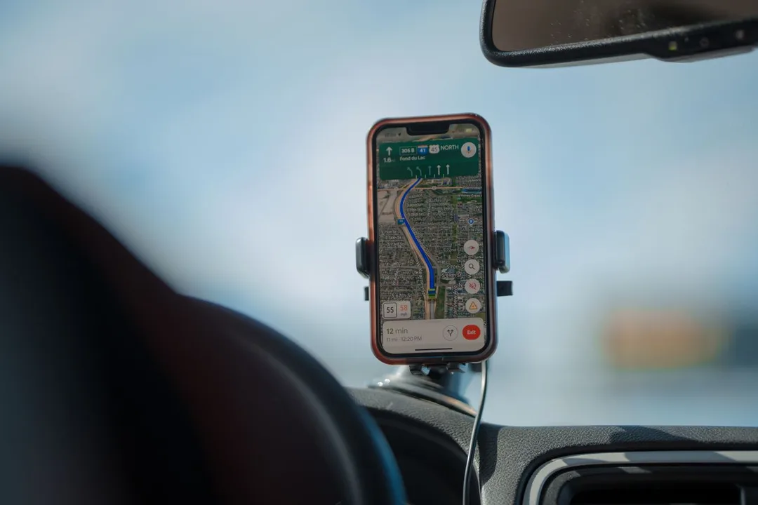 Phone mounted on a dashboard showing a navigation map