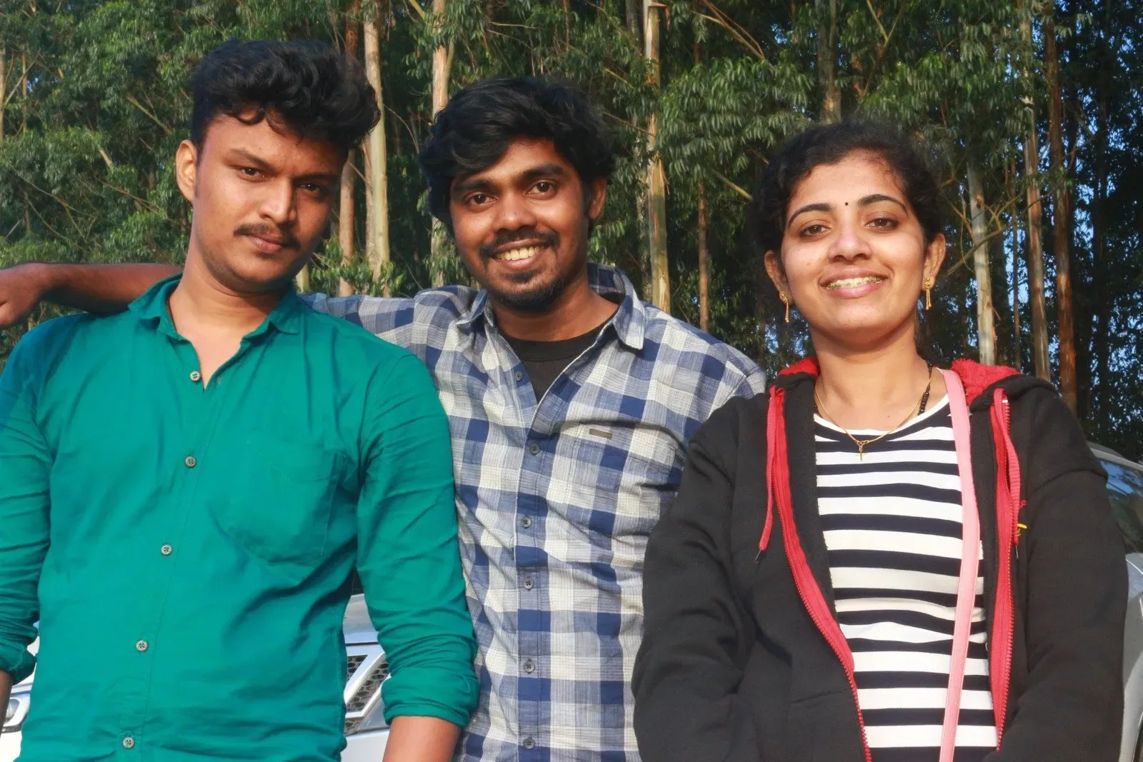 Three members of the Acube team outdoors in Munnar