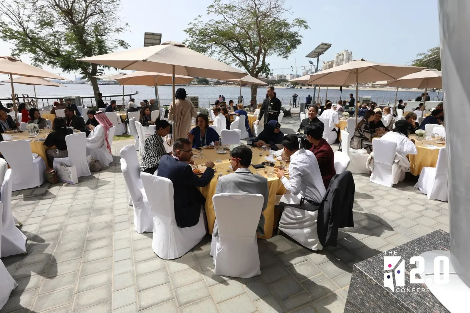 Delegates at tables outdoors at the conference